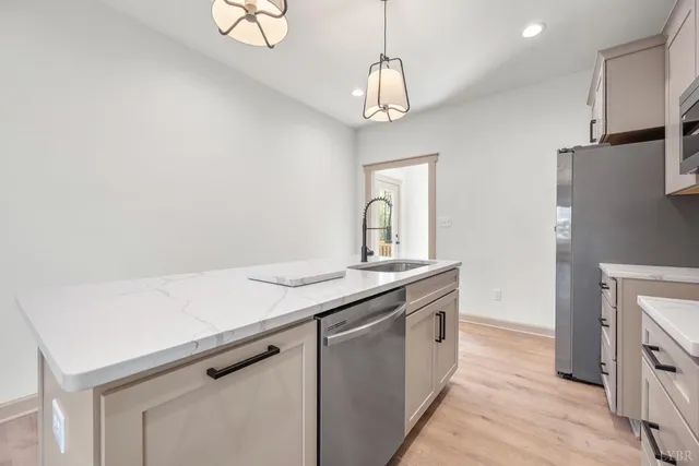 a kitchen with a sink and a refrigerator