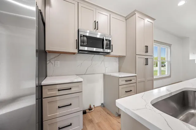 a kitchen with a sink and a stove top oven