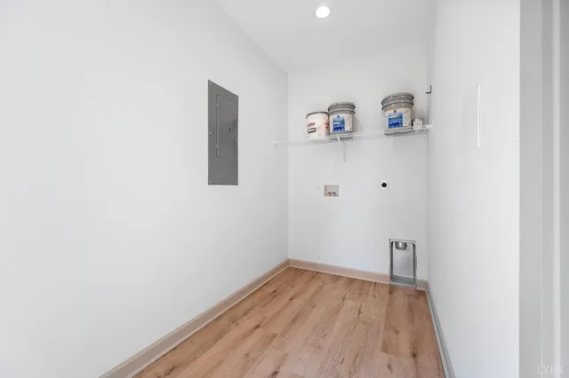 a view of utility room with closet and wooden floor