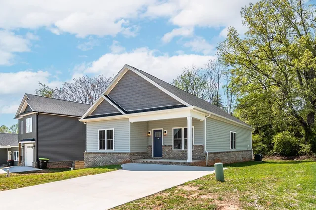 a front view of house with yard outdoor seating and barbeque oven
