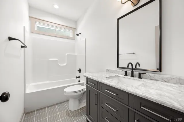 an empty room with window and ceiling fan