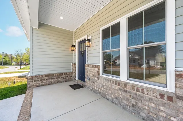 a view of a house with backyard and balcony