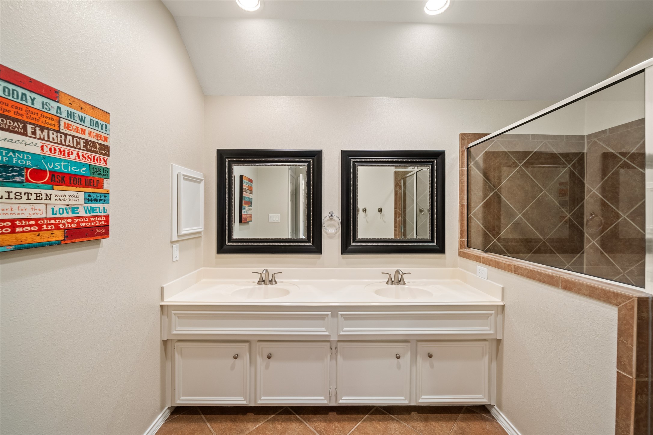 2613 Link Road Houston, TX 77009 - Photo 5 of 28 The primary bathroom features dual vanities, plenty of counter space, a roomy storage closet, and an oversized walk-in shower.
