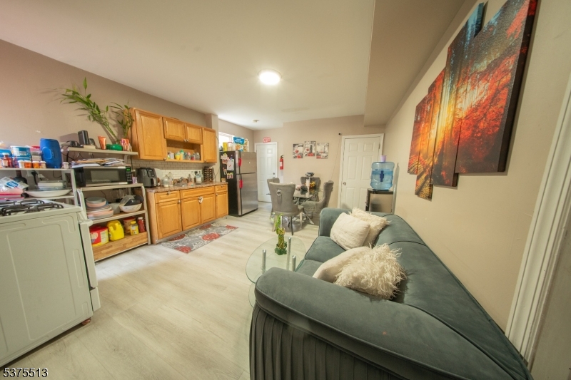 56 North York Street Paterson, NJ 07524 - Photo 11 of 20 a living room with furniture and a flat screen tv