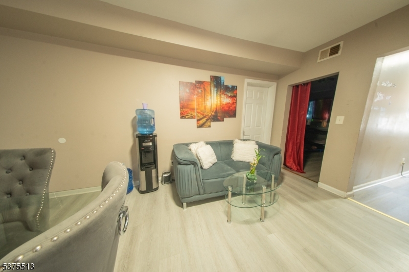 56 North York Street Paterson, NJ 07524 - Photo 12 of 20 a living room with furniture and a flat screen tv