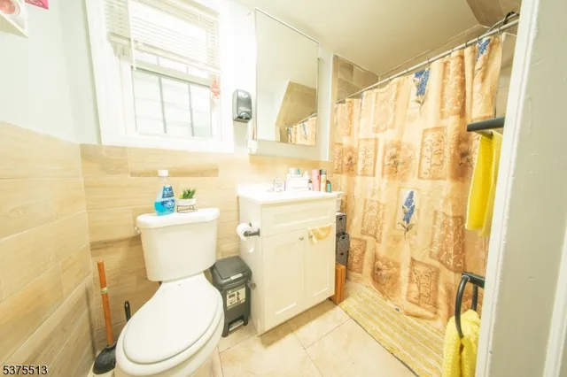 a white toilet sitting next to a bathroom sink and a shower