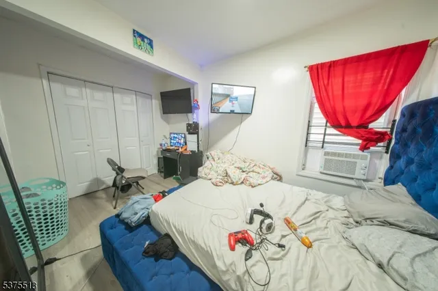 a bedroom with a bed and dresser with mirror