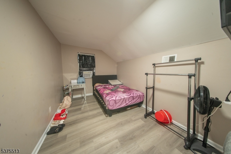 56 North York Street Paterson, NJ 07524 - Photo 18 of 20 a bedroom with a bed and gym equipment