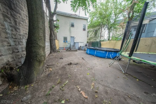 a view of backyard with outdoor and trees