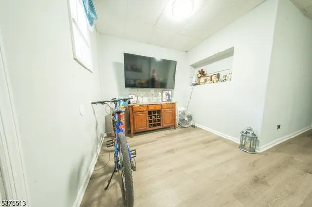 a view of a livingroom with wooden floor and a flat screen tv