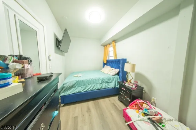 a bedroom with a bed and a dresser