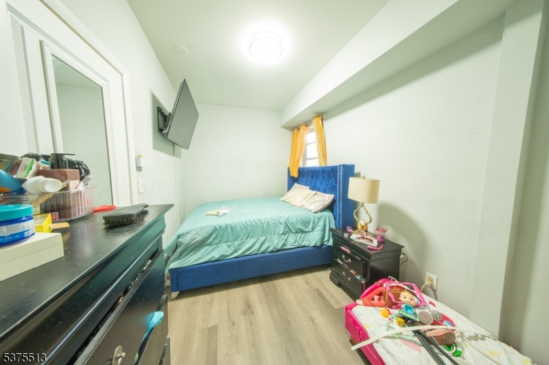 56 North York Street Paterson, NJ 07524 - Photo 8 of 20 a bedroom with a bed and a dresser