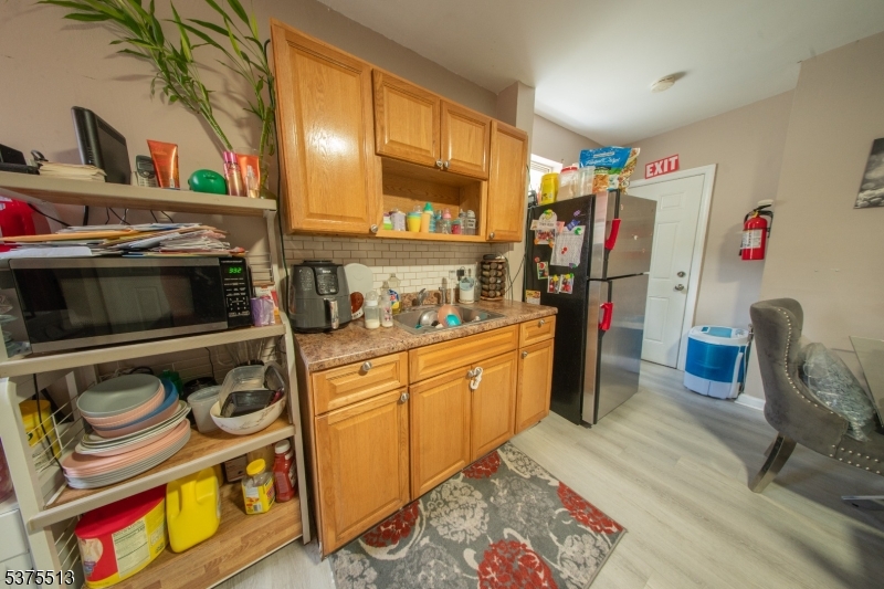56 North York Street Paterson, NJ 07524 - Photo 10 of 20 a kitchen with stainless steel appliances granite countertop a refrigerator and a stove top oven