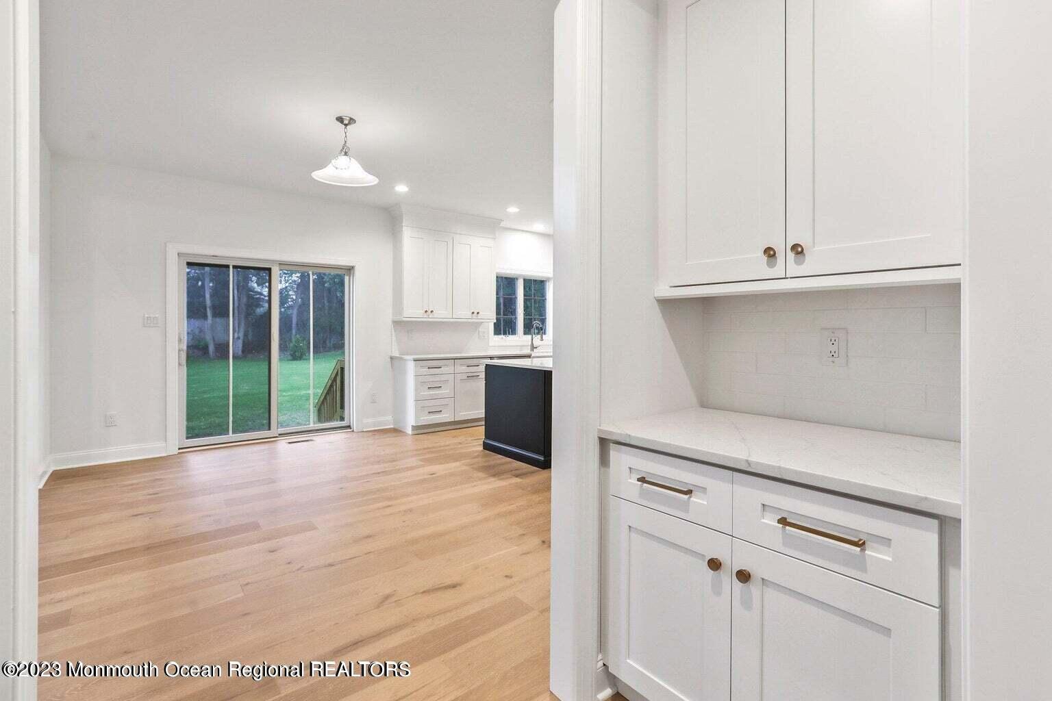 2 Crine Road Morganville, NJ 07751 - Photo 6 of 15 a view of a kitchen with white cabinets and a window