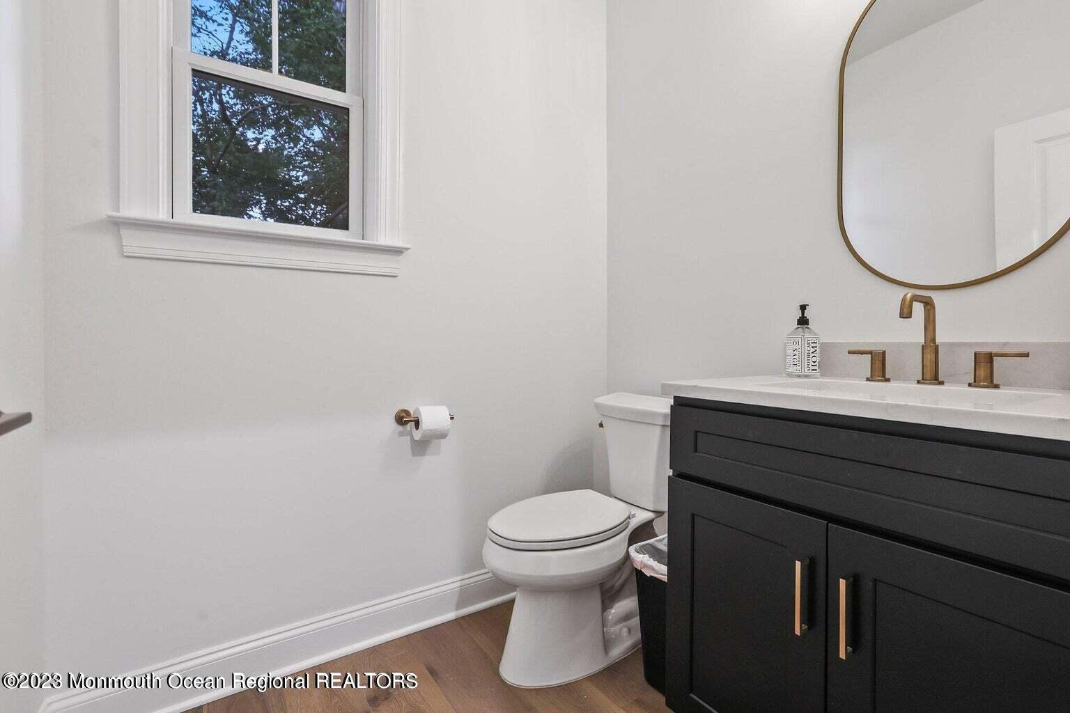 2 Crine Road Morganville, NJ 07751 - Photo 7 of 15 a bathroom with a toilet a sink and a mirror