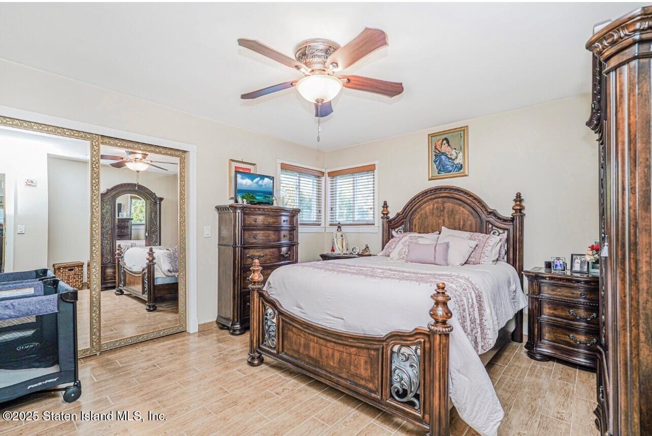 31 Plank Road Staten Island, NY 10314 - Photo 14 of 30 a bedroom with bed and a chandelier