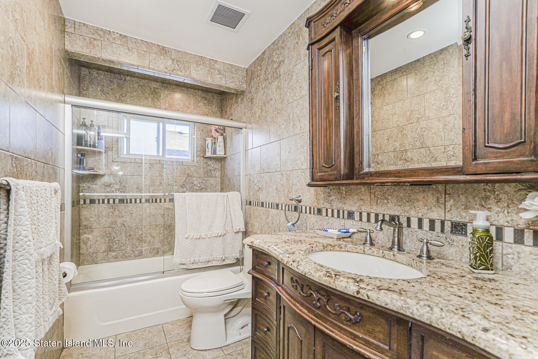 31 Plank Road Staten Island, NY 10314 - Photo 15 of 30 a bathroom with a granite countertop sink a toilet and shower
