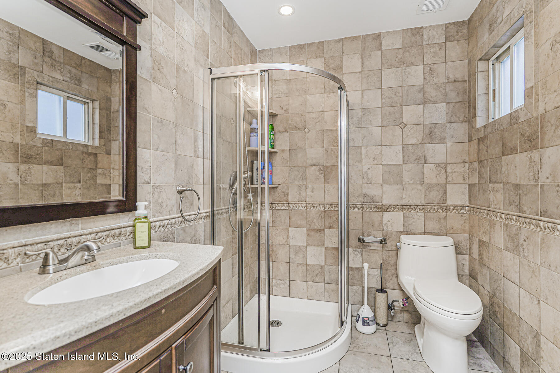 31 Plank Road Staten Island, NY 10314 - Photo 18 of 30 a bathroom with a sink toilet vanity and shower