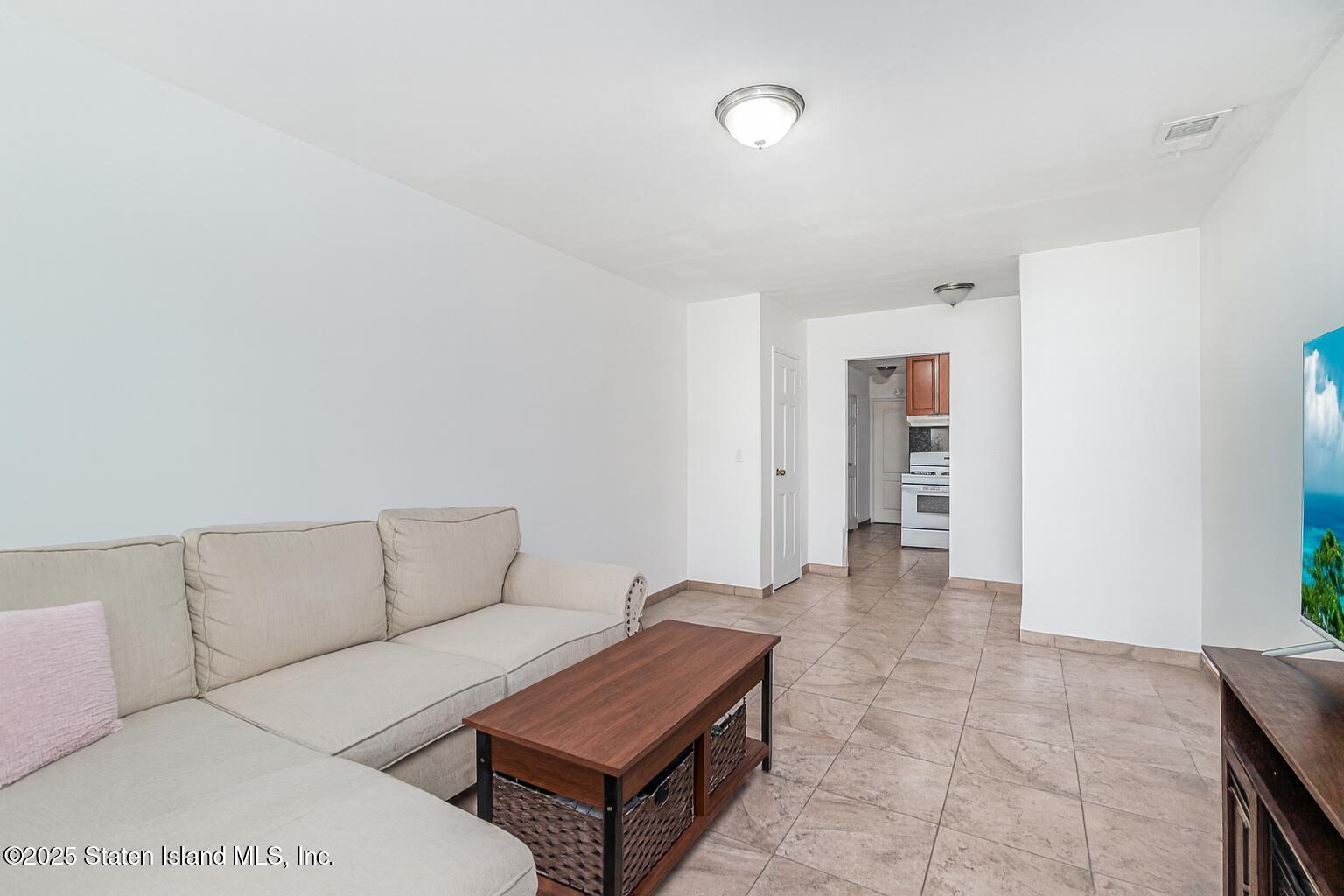 31 Plank Road Staten Island, NY 10314 - Photo 21 of 30 a living room with furniture and a rug