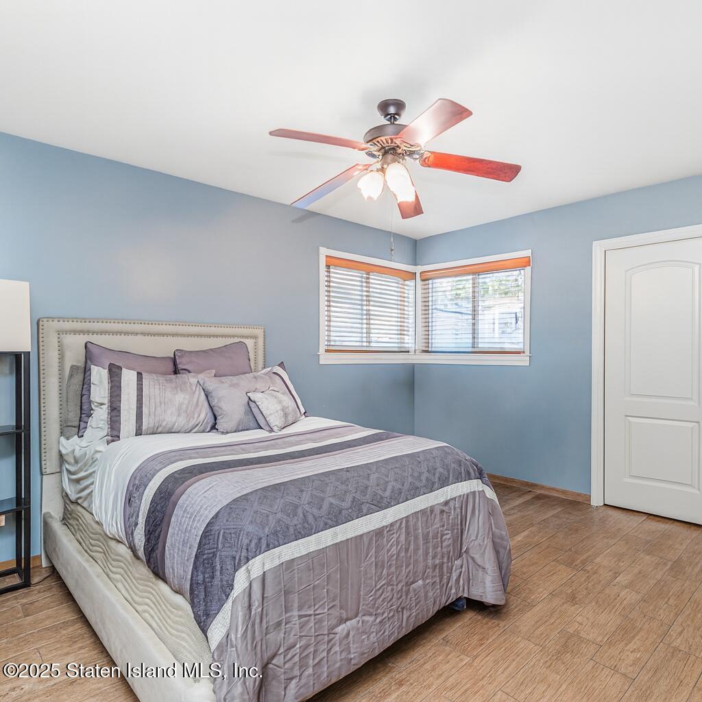 31 Plank Road Staten Island, NY 10314 - Photo 27 of 30 a bedroom with a large bed and a chandelier