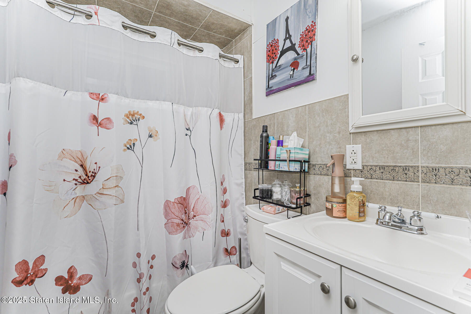 31 Plank Road Staten Island, NY 10314 - Photo 28 of 30 a bathroom with a sink a toilet and a shower curtain
