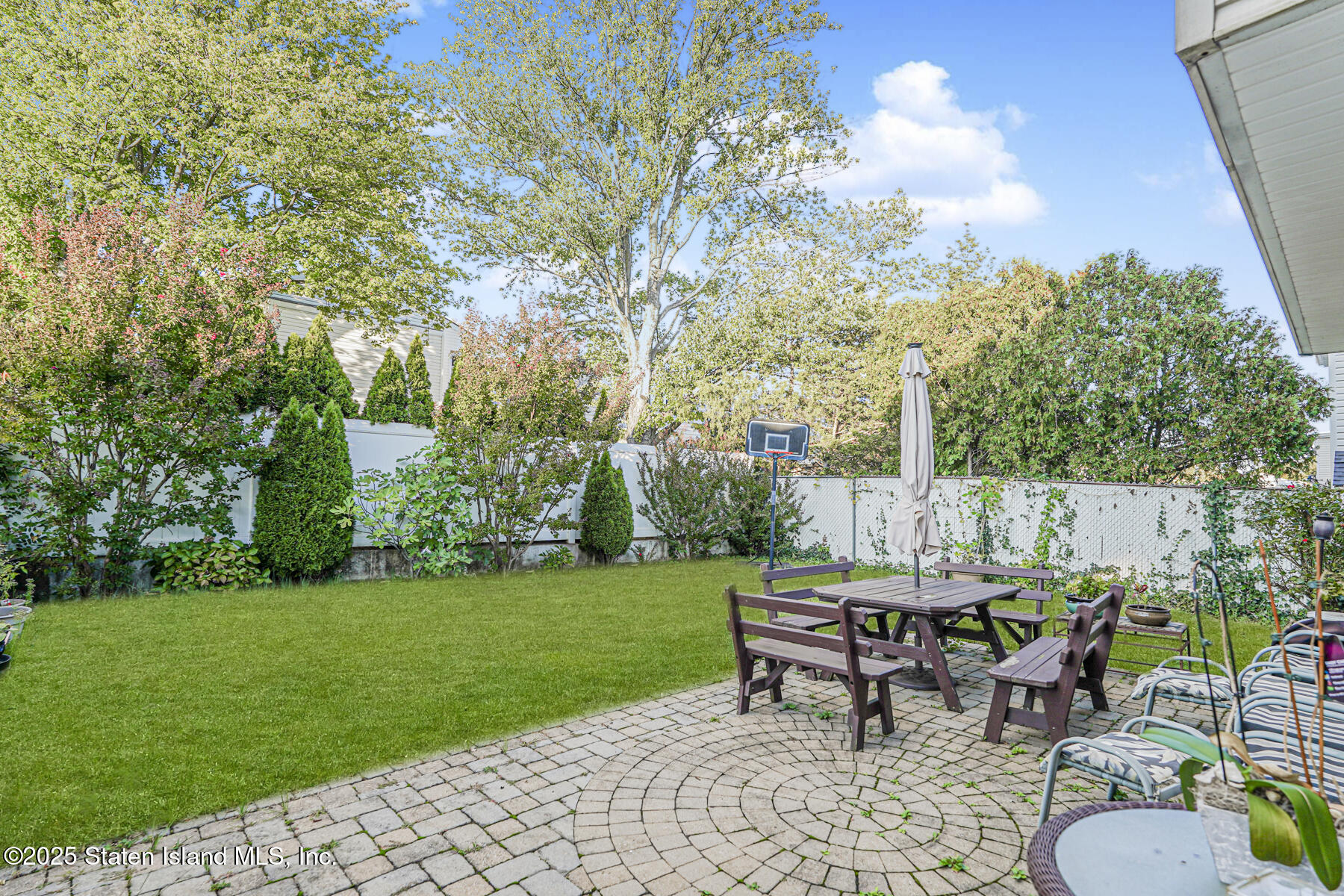 31 Plank Road Staten Island, NY 10314 - Photo 4 of 30 a view of a table and chairs in backyard of the house