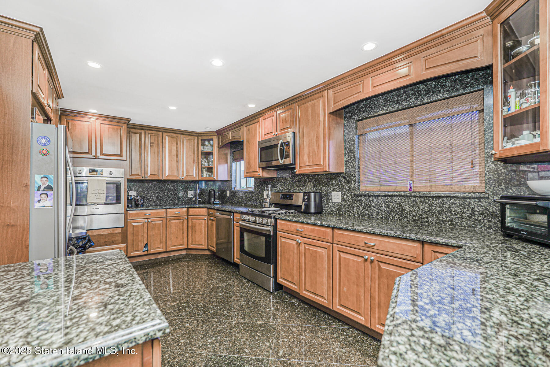 31 Plank Road Staten Island, NY 10314 - Photo 7 of 30 a kitchen with stainless steel appliances granite countertop a stove a sink and a microwave