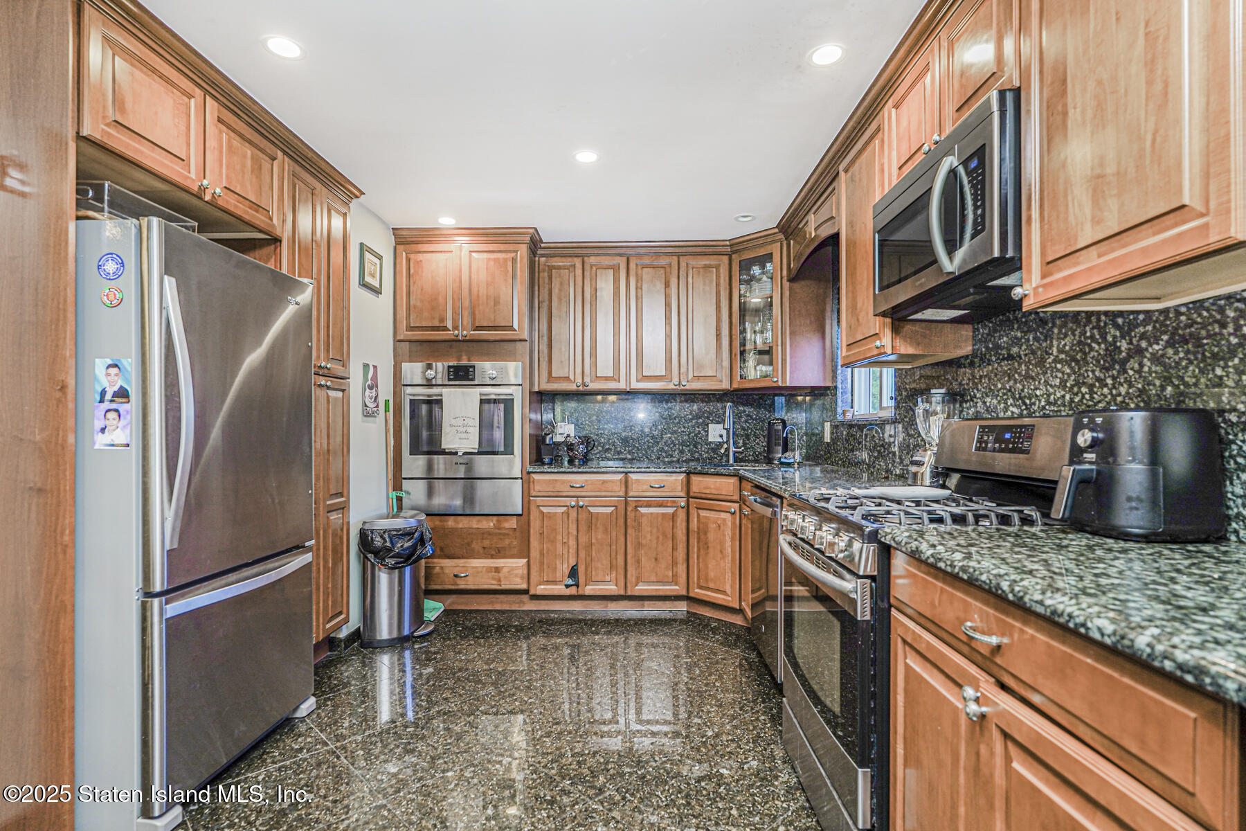 31 Plank Road Staten Island, NY 10314 - Photo 8 of 30 a kitchen with stainless steel appliances granite countertop a refrigerator a stove and a sink with wooden cabinets