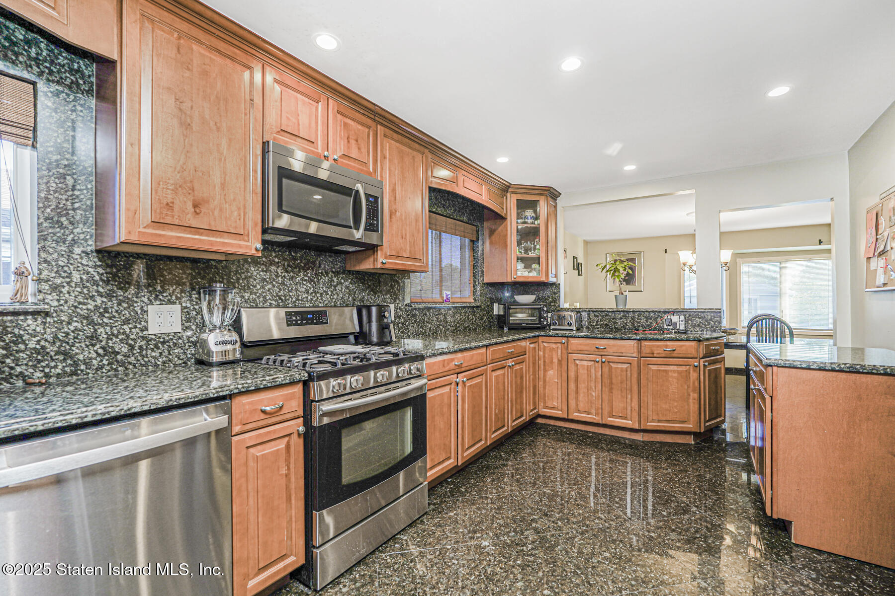 31 Plank Road Staten Island, NY 10314 - Photo 9 of 30 a kitchen with stainless steel appliances granite countertop a stove a sink and a granite counter tops