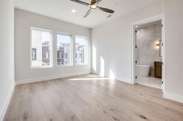 a spacious bedroom with a bed and a large window