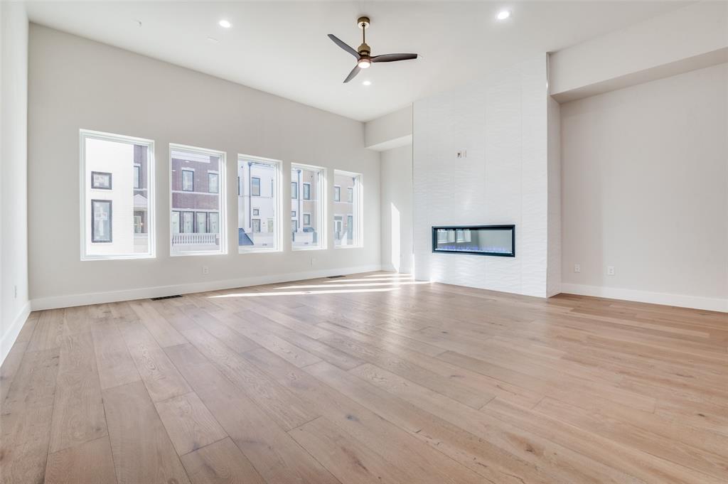 250 East Dallas Road, Unit 124 Grapevine, TX 76051 - Photo 5 of 37 a view of an empty room with a window and wooden floor