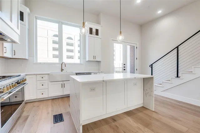 a kitchen with stainless steel appliances granite countertop a refrigerator sink and cabinets