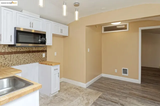a kitchen with granite countertop a sink and a stove top oven