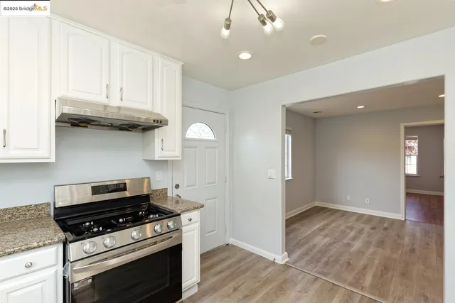 a kitchen with granite countertop a stove and a sink