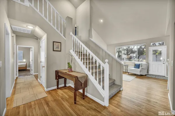 a view of an entryway with wooden floor and a way to kitchen