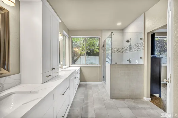 a large white bathroom with a large mirror