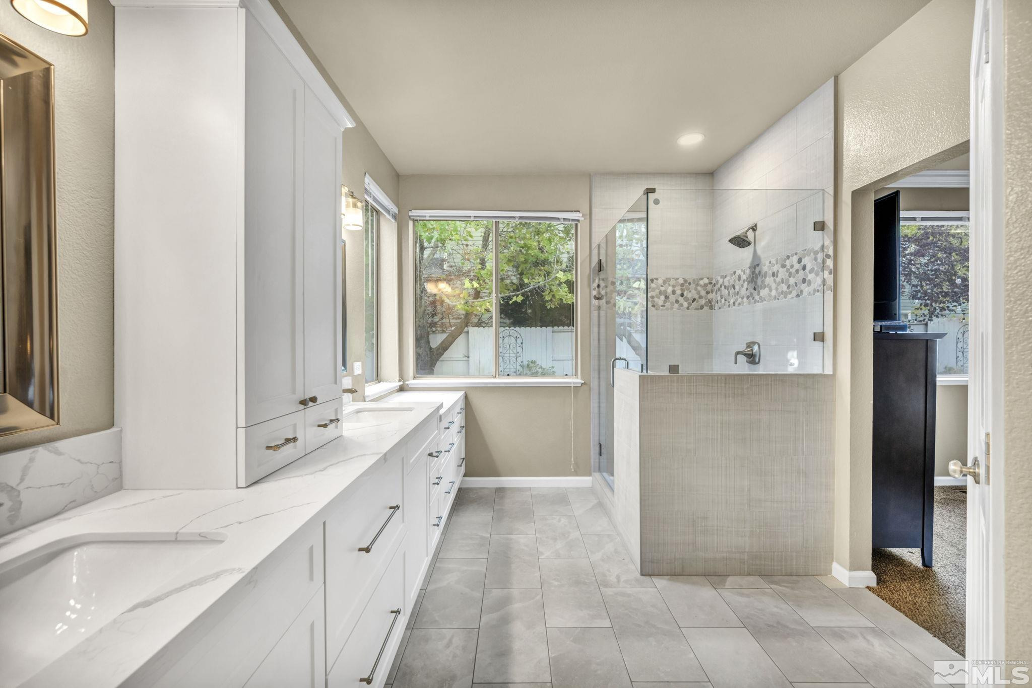 4731 Ellicott Way Reno, NV 89519 - Photo 22 of 36 a large white bathroom with a large mirror