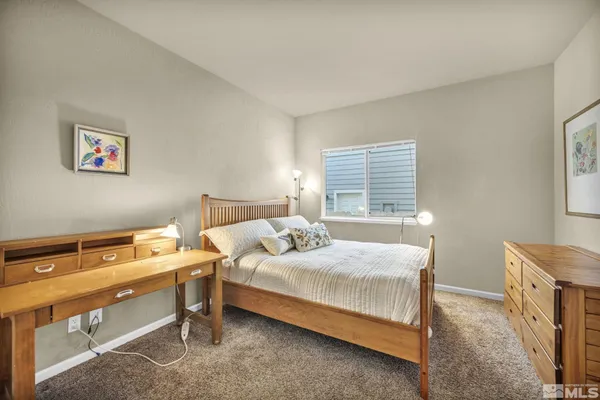 a bedroom with a bed and a desk