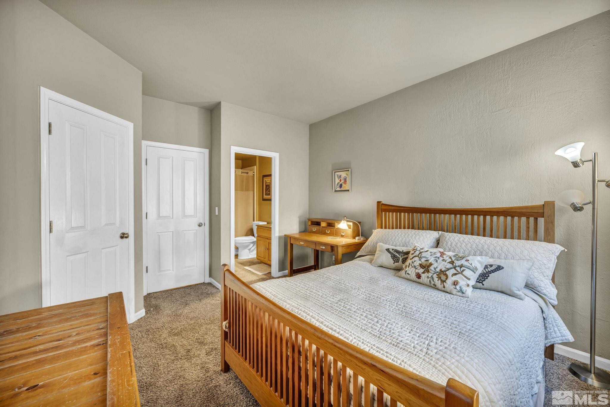 4731 Ellicott Way Reno, NV 89519 - Photo 26 of 36 a bed sitting in a bedroom and table next to a window