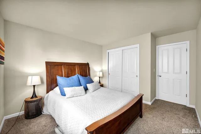 a bedroom with a bed and a lamp