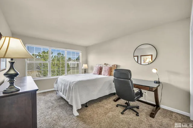 a view of a livingroom with workspace and a window