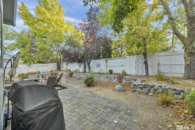 a backyard of a house with table and chairs