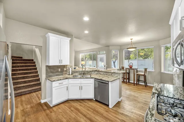 a kitchen with a sink stove and cabinets
