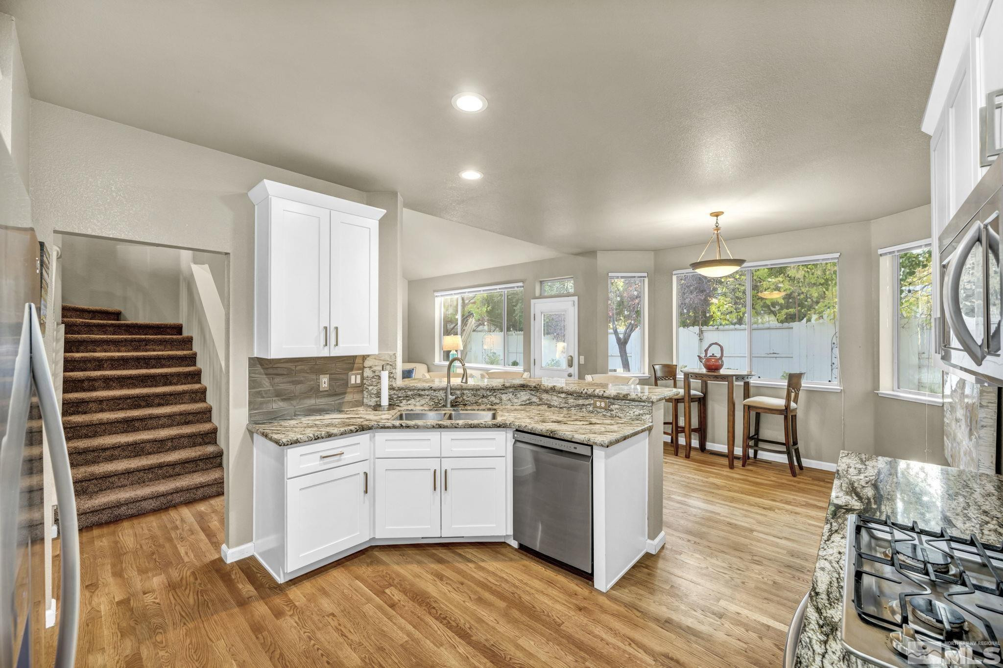 4731 Ellicott Way Reno, NV 89519 - Photo 7 of 36 a kitchen with a sink stove and cabinets
