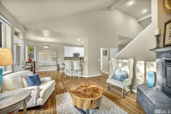 a living room with furniture and a dining table with kitchen view