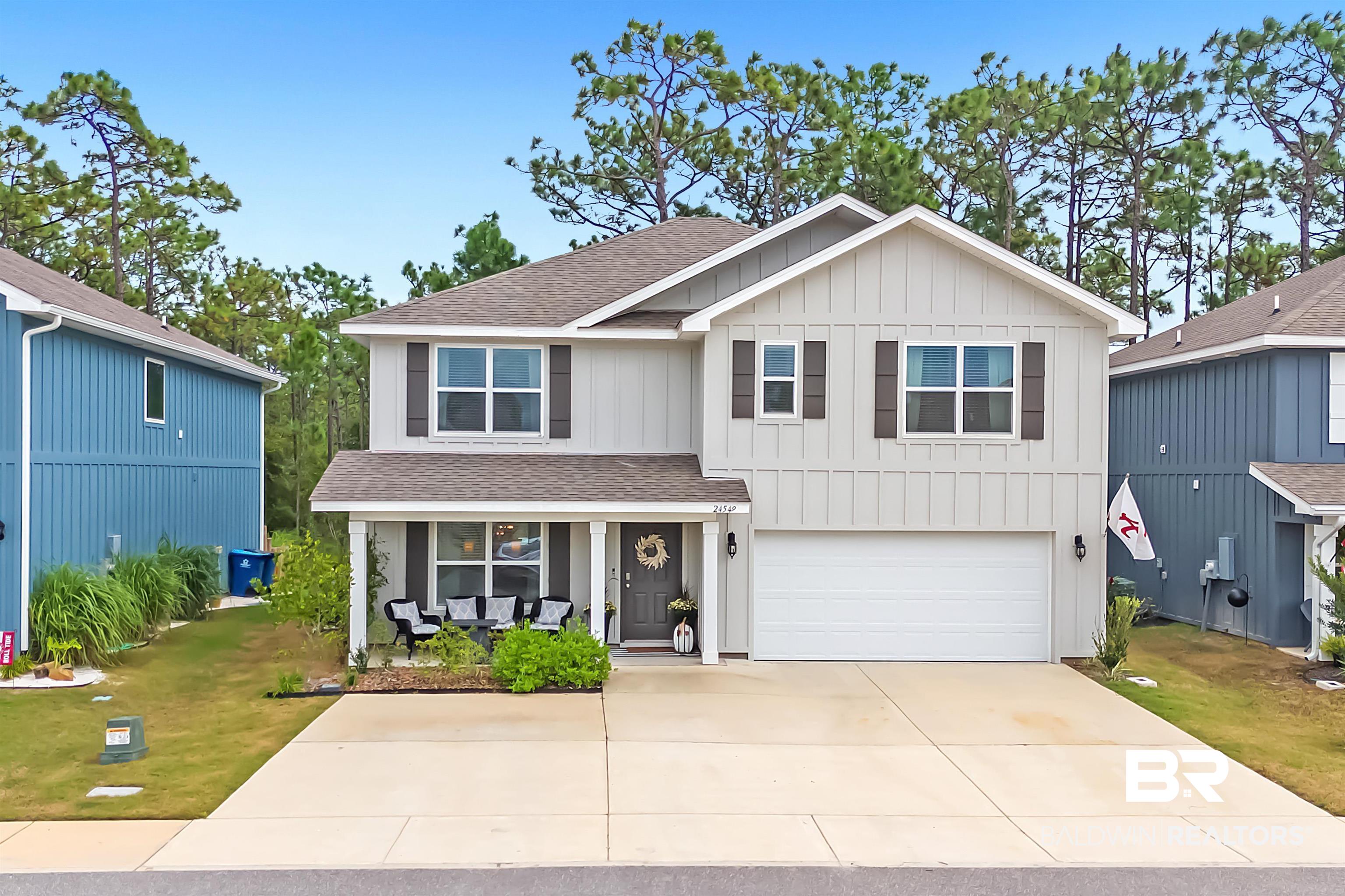 24549 Broken Sound Loop Orange Beach, AL 36561 - Photo 45 of 57 View of front facade featuring a garage and a front lawn