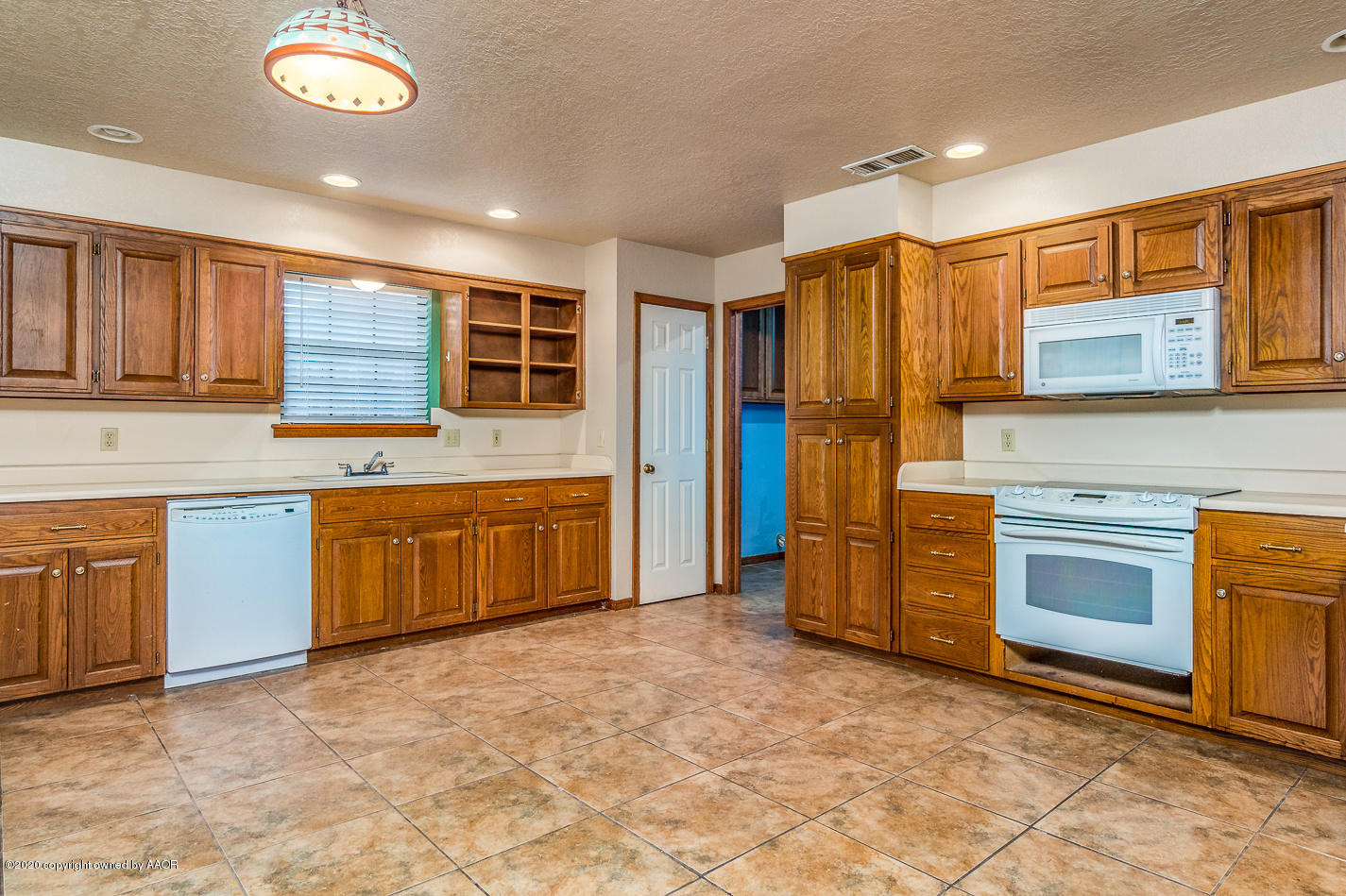 4208 Jamie Trail Amarillo, TX 79110 - Photo 3 of 23 a kitchen with stainless steel appliances granite countertop a stove a sink and a refrigerator