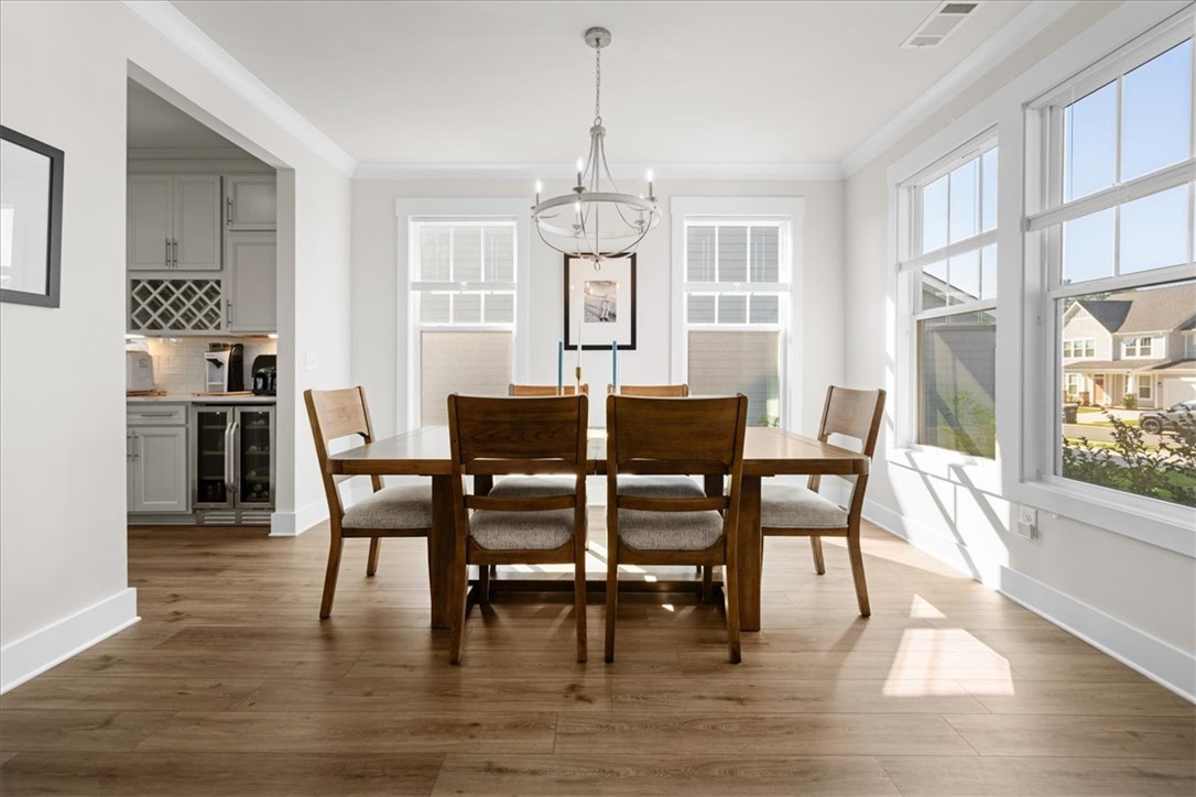 621 Wh Kay Lane Anderson, SC 29621 - Photo 2 of 50 A refined dining room with rich luxury vinyl plank flooring and abundant natural light.