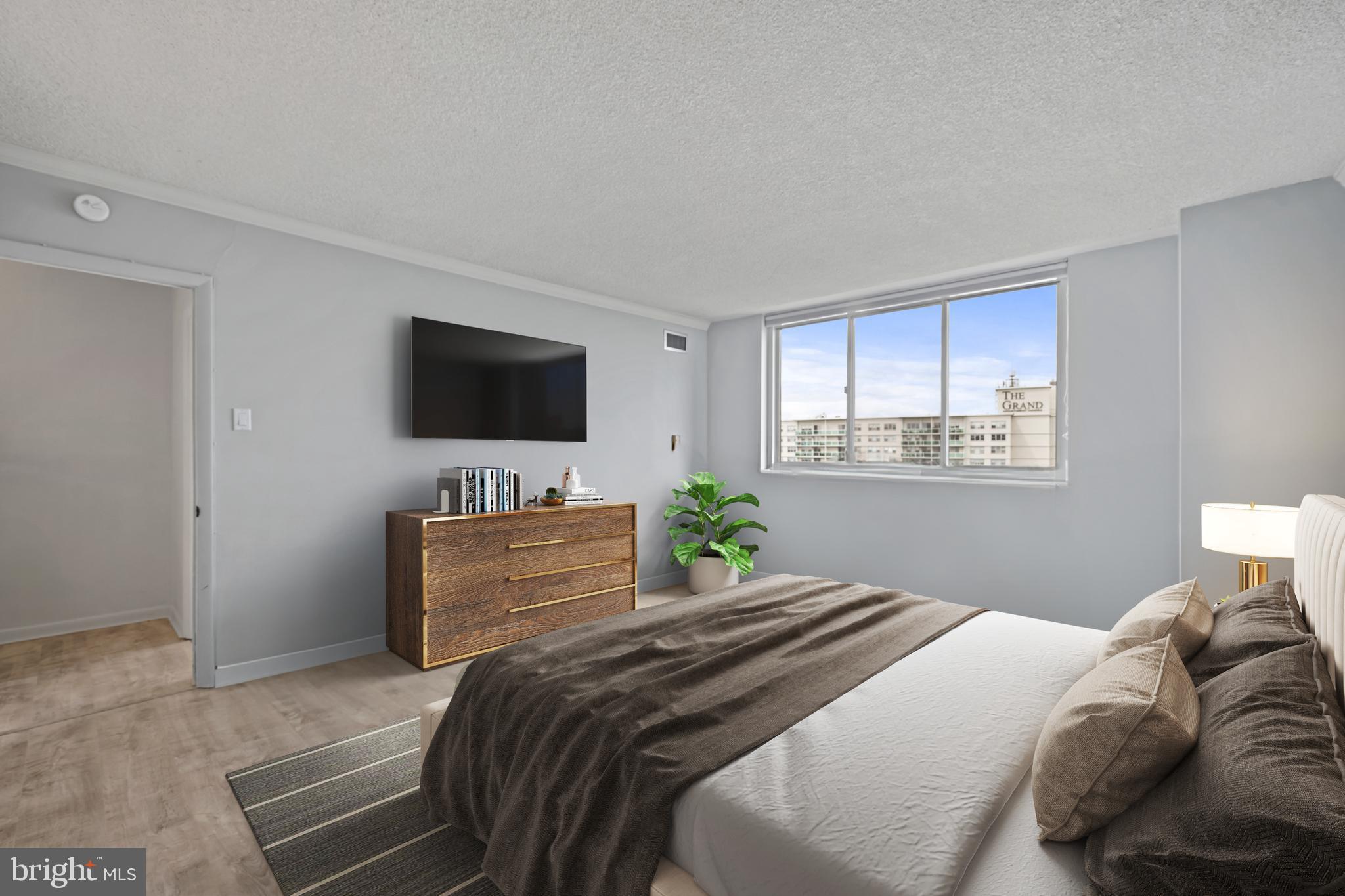 1840 Frontage Road, Unit 1501 Cherry Hill, NJ 08034 - Photo 13 of 20 a bedroom with a bed and a flat screen tv