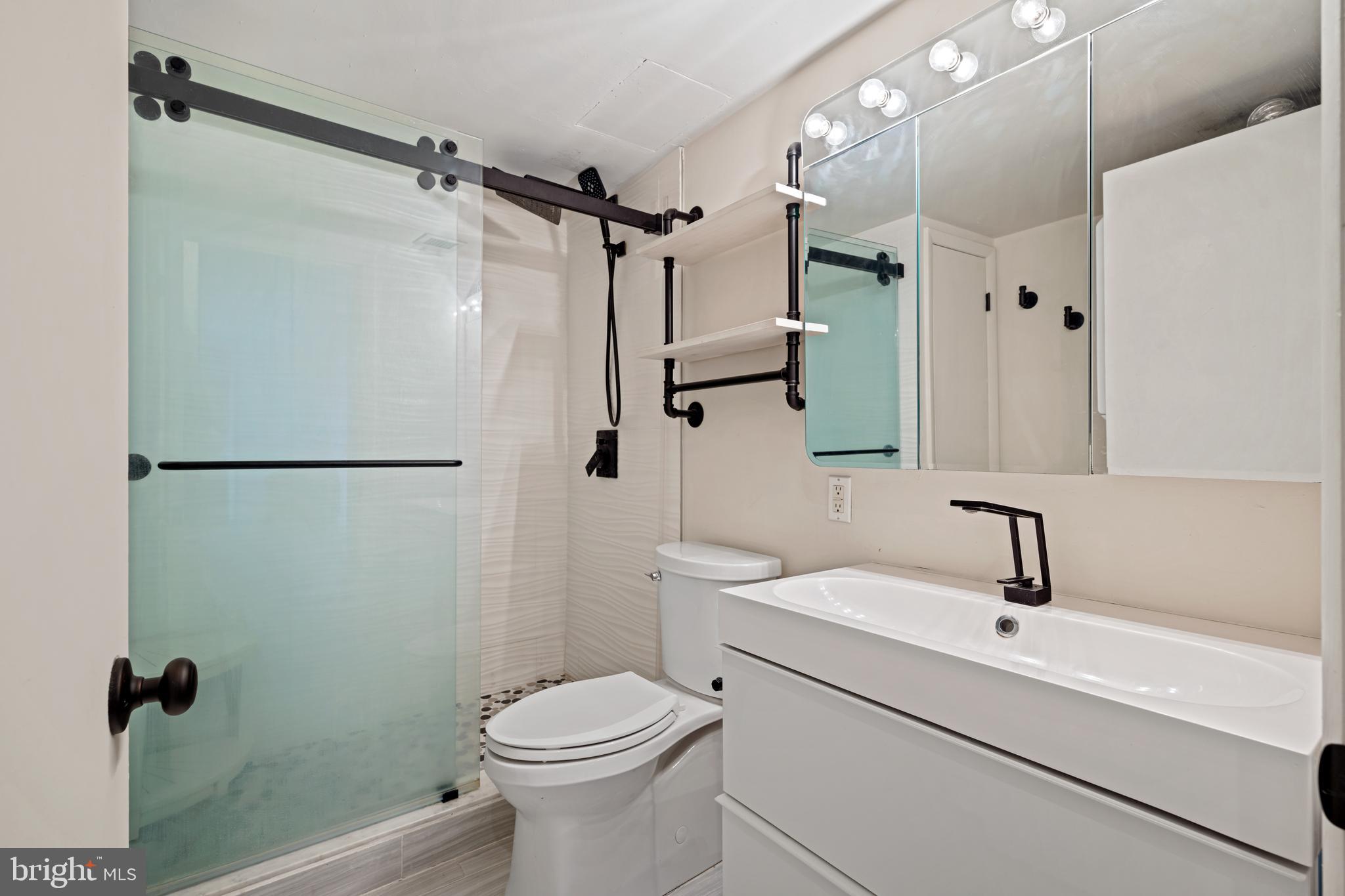 1840 Frontage Road, Unit 1501 Cherry Hill, NJ 08034 - Photo 15 of 20 a bathroom with a sink a toilet a mirror and shower